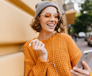 Joyful girl watching online courses on her phone